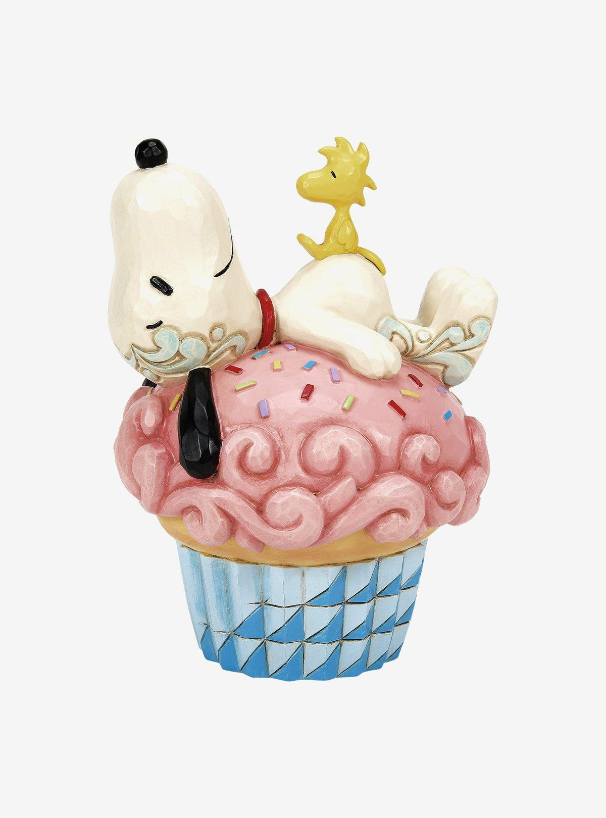 Figura Jim Shore de Snoopy durmiendo sobre un cupcake