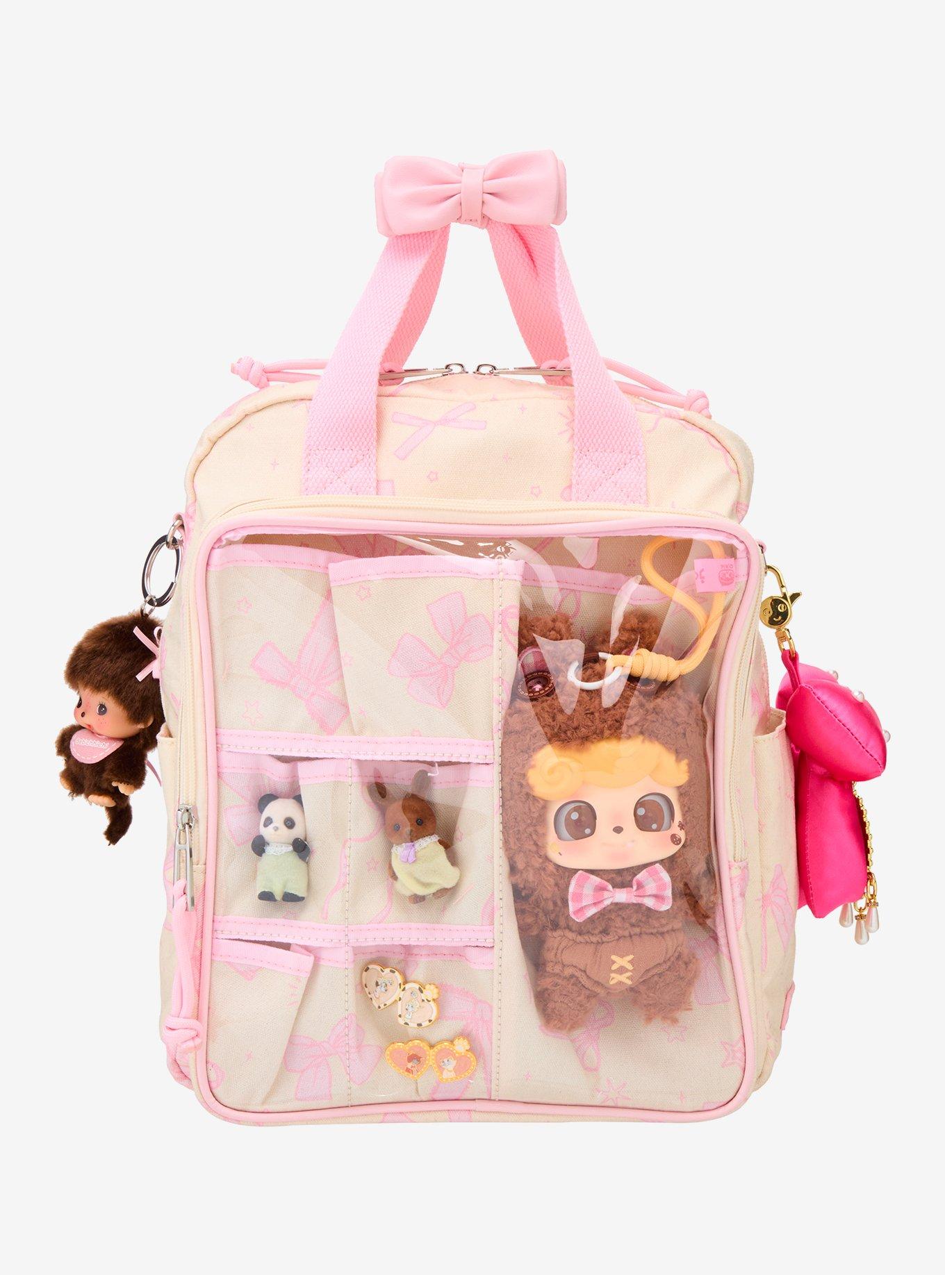 Mochila mini con lazos rosados y bolsillo transparente