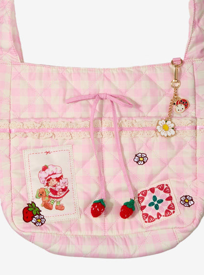 Cartera bandolera rosada de cuadros de Strawberry Shortcake
