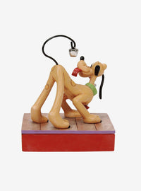 Figura navideña de Pluto con campanas