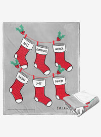 Manta Friends con diseño de medias navideñas