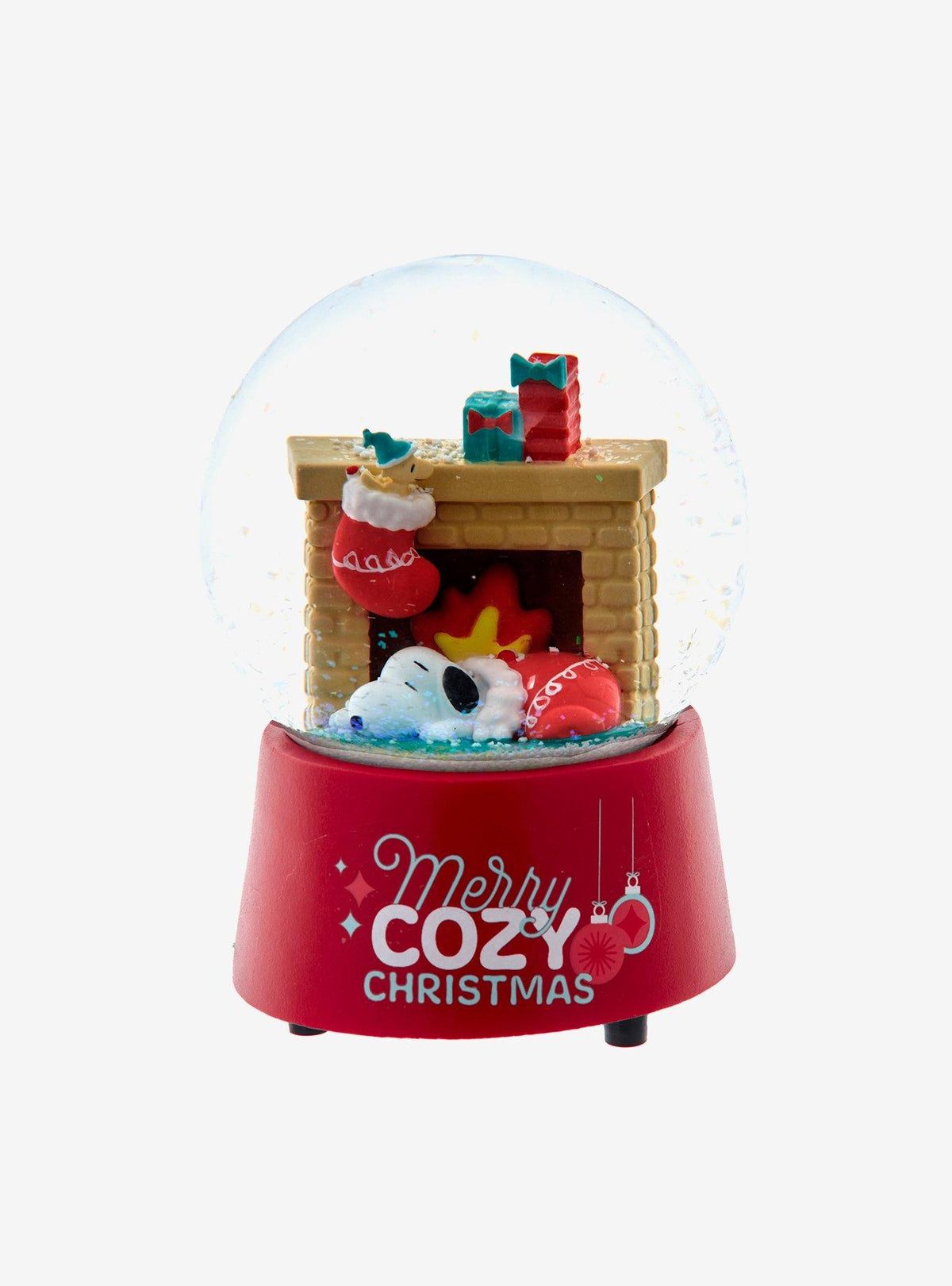 Globo de nieve musical de Snoopy junto a la chimenea