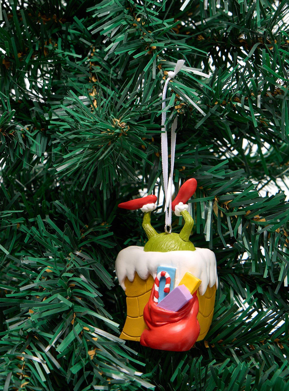 Adorno navideño de El Grinch en una chimenea