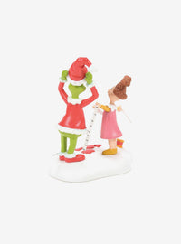 Figura de El Grinch probándose el traje de Santa