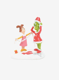 Figura de El Grinch probándose el traje de Santa