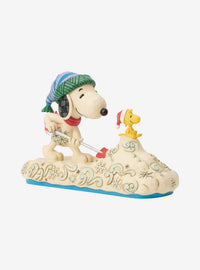 Figura Jim Shore de Snoopy paleando nieve