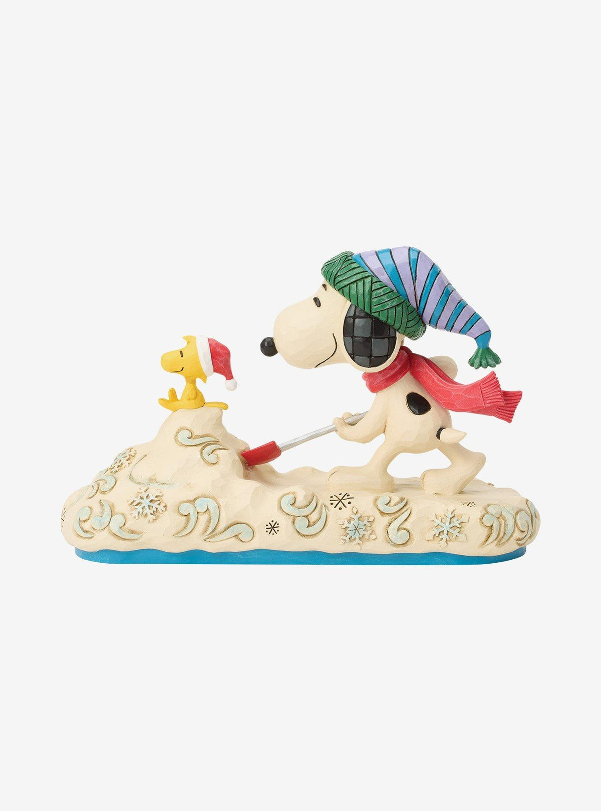 Figura Jim Shore de Snoopy paleando nieve