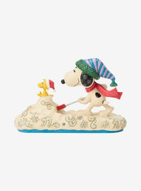 Figura Jim Shore de Snoopy paleando nieve