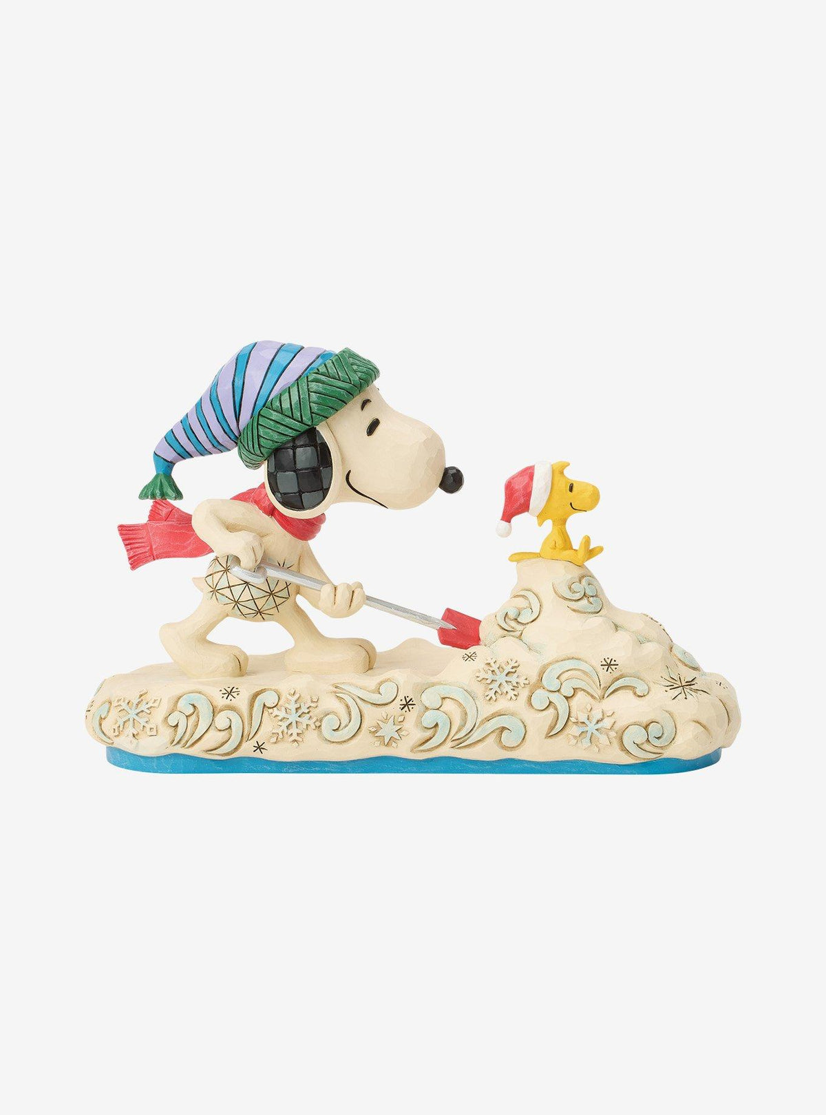 Figura Jim Shore de Snoopy paleando nieve