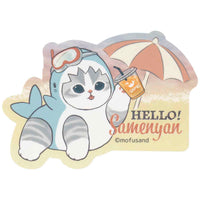 Sticker Mofusand: gatito tiburón en la playa