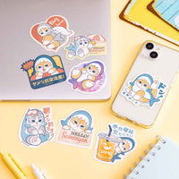 Sticker Mofusand: gatito tiburón en la playa
