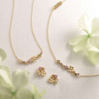 Aros Rapunzel en oro amarillo K10 con piedras de colores